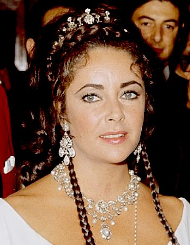 Liz Taylor wearing a diamond tiara and pearl necklace