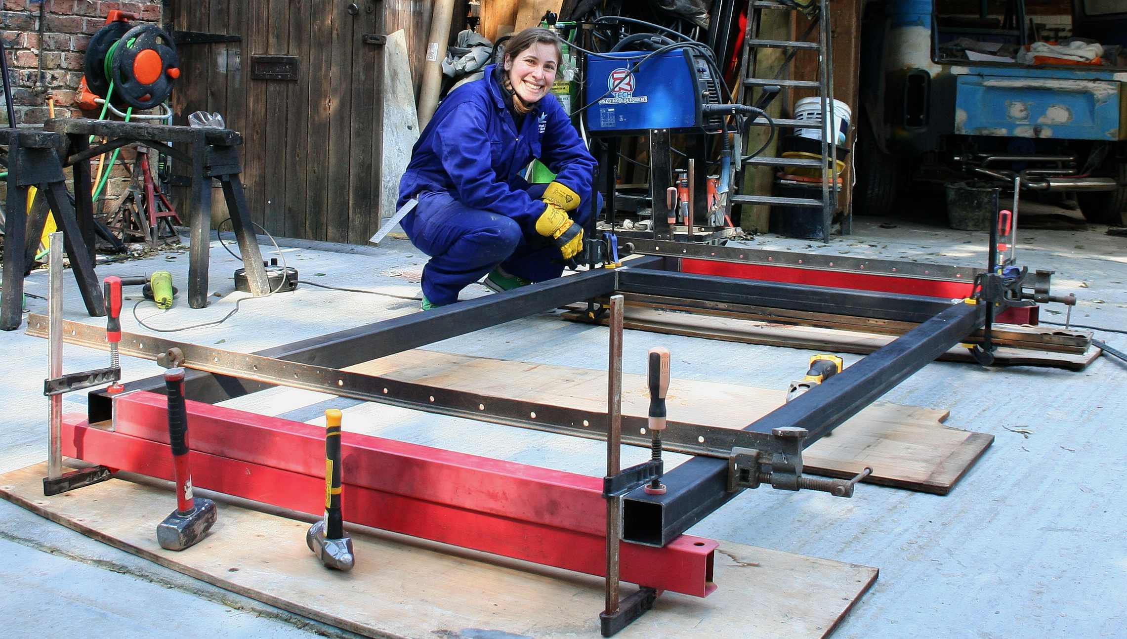 Lolita helping to make a steel frame for a wind turbine project